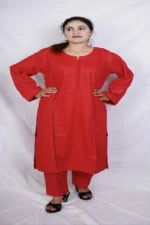 Woman in a red kurta design for women, front view, with lace trim sleeves, paired with matching red salwar and black heelsWoman in a red kurta design for women, front view, with lace trim sleeves, paired with matching red salwar and black heels